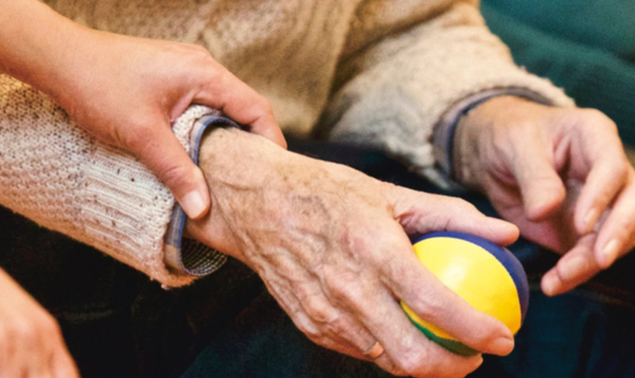 Elderly person with someone holding their wrist